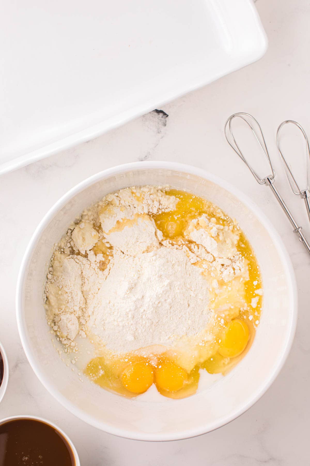 cake mix, eggs, milk and melted butter in a mixing bowl
