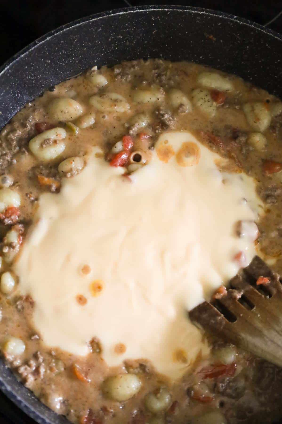 cheddar soup added to skillet with ground beef and gnocchi mixture