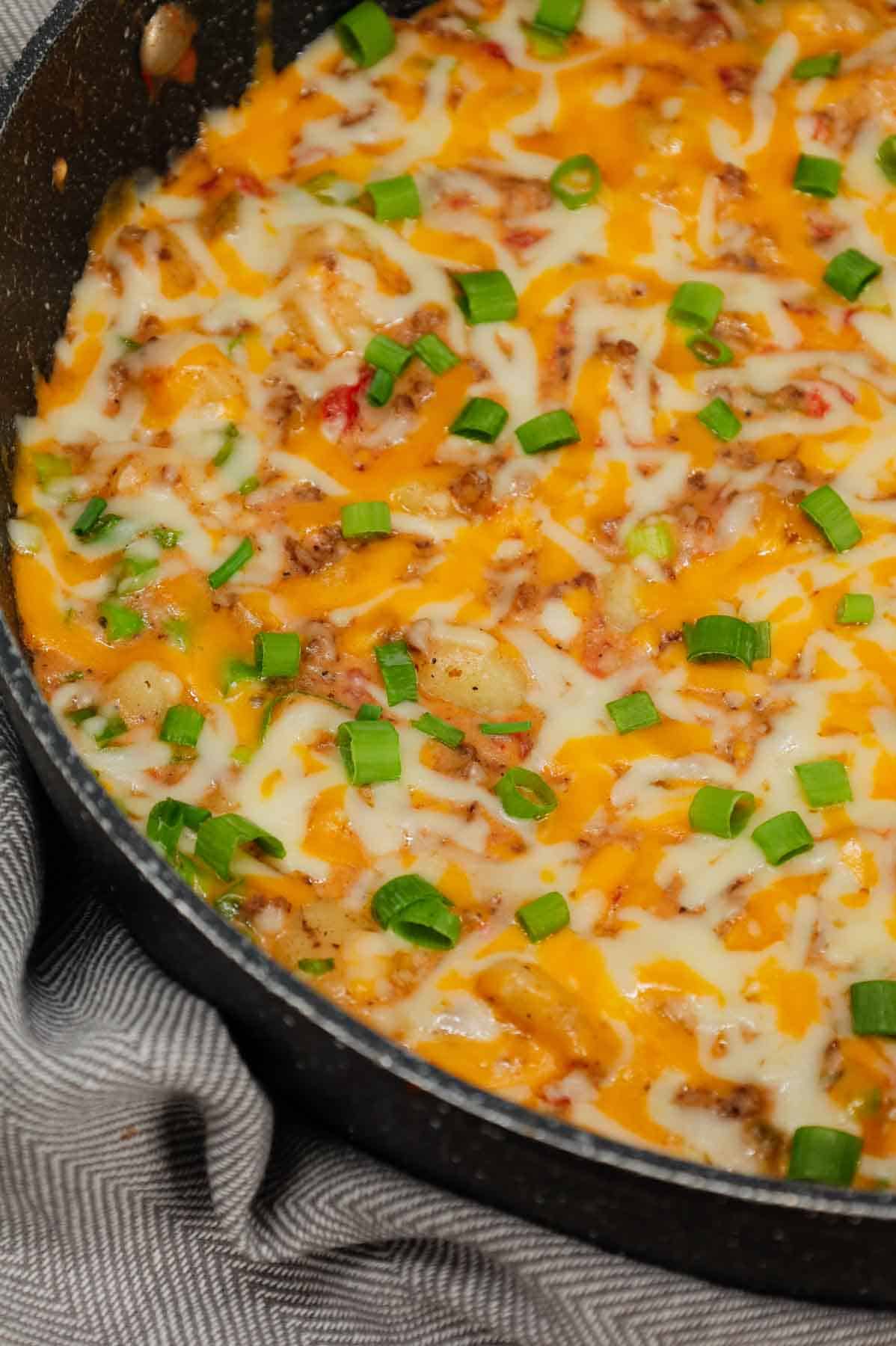 Cheeseburger Gnocchi is a hearty ground beef dinner recipe loaded with potato gnocchi, Rotel, chopped green onions and shredded cheese with a creamy sauce made from cheddar soup and milk.