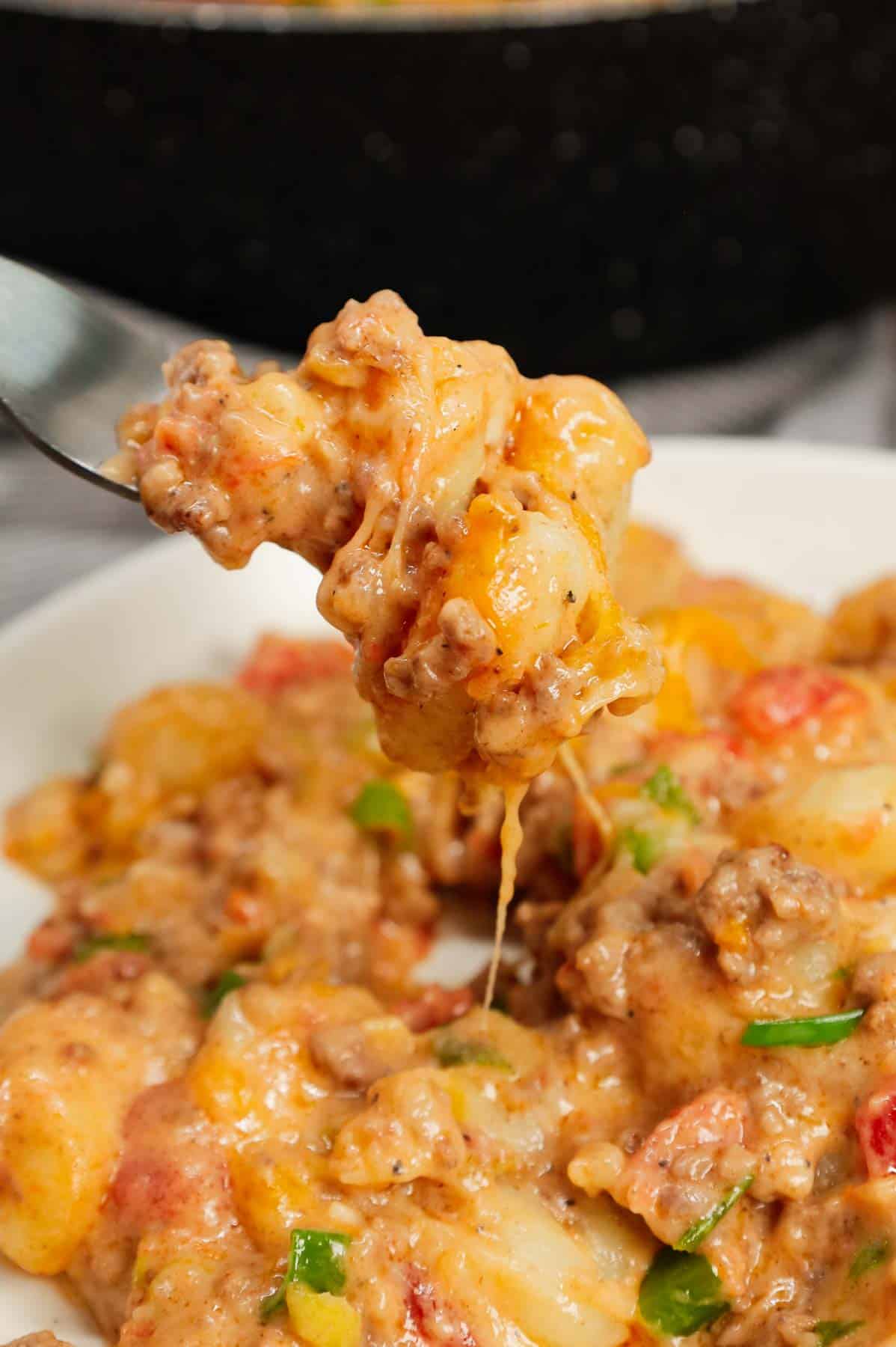 Cheeseburger Gnocchi is a hearty ground beef dinner recipe loaded with potato gnocchi, Rotel, chopped green onions and shredded cheese with a creamy sauce made from cheddar soup and milk.