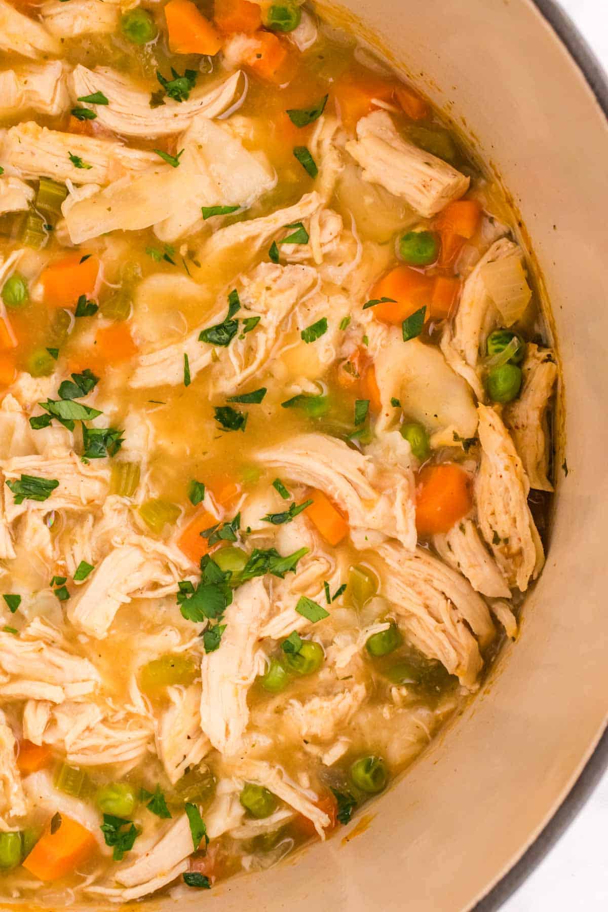 Chicken and Dumplings with Tortillas is a twist on a classic comfort food recipe loaded with shredded chicken breast, carrots, celery, onion, peas and flour tortilla recipes all cooked in a delicious chicken broth.