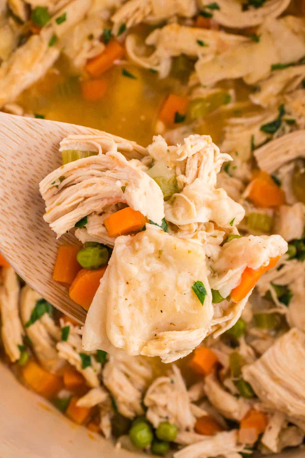 Chicken and Dumplings with Tortillas is a twist on a classic comfort food recipe loaded with shredded chicken breast, carrots, celery, onion, peas and flour tortilla recipes all cooked in a delicious chicken broth.