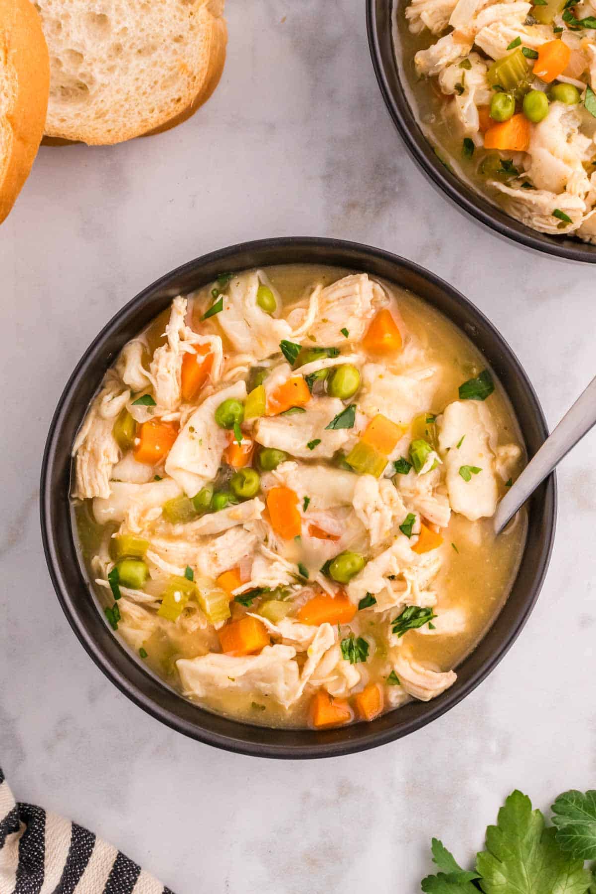 Chicken and Dumplings with Tortillas is a twist on a classic comfort food recipe loaded with shredded chicken breast, carrots, celery, onion, peas and flour tortilla recipes all cooked in a delicious chicken broth.