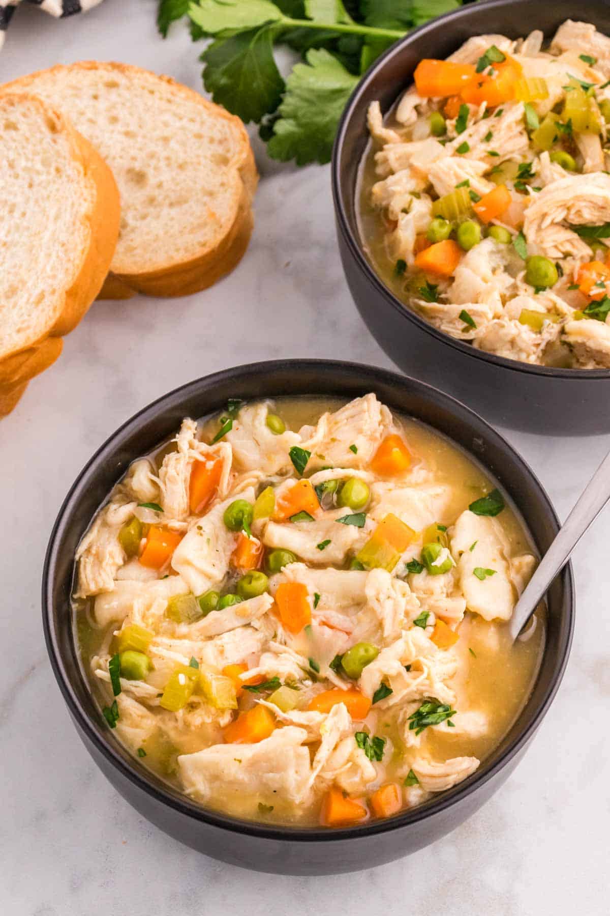 Chicken and Dumplings with Tortillas is a twist on a classic comfort food recipe loaded with shredded chicken breast, carrots, celery, onion, peas and flour tortilla recipes all cooked in a delicious chicken broth.