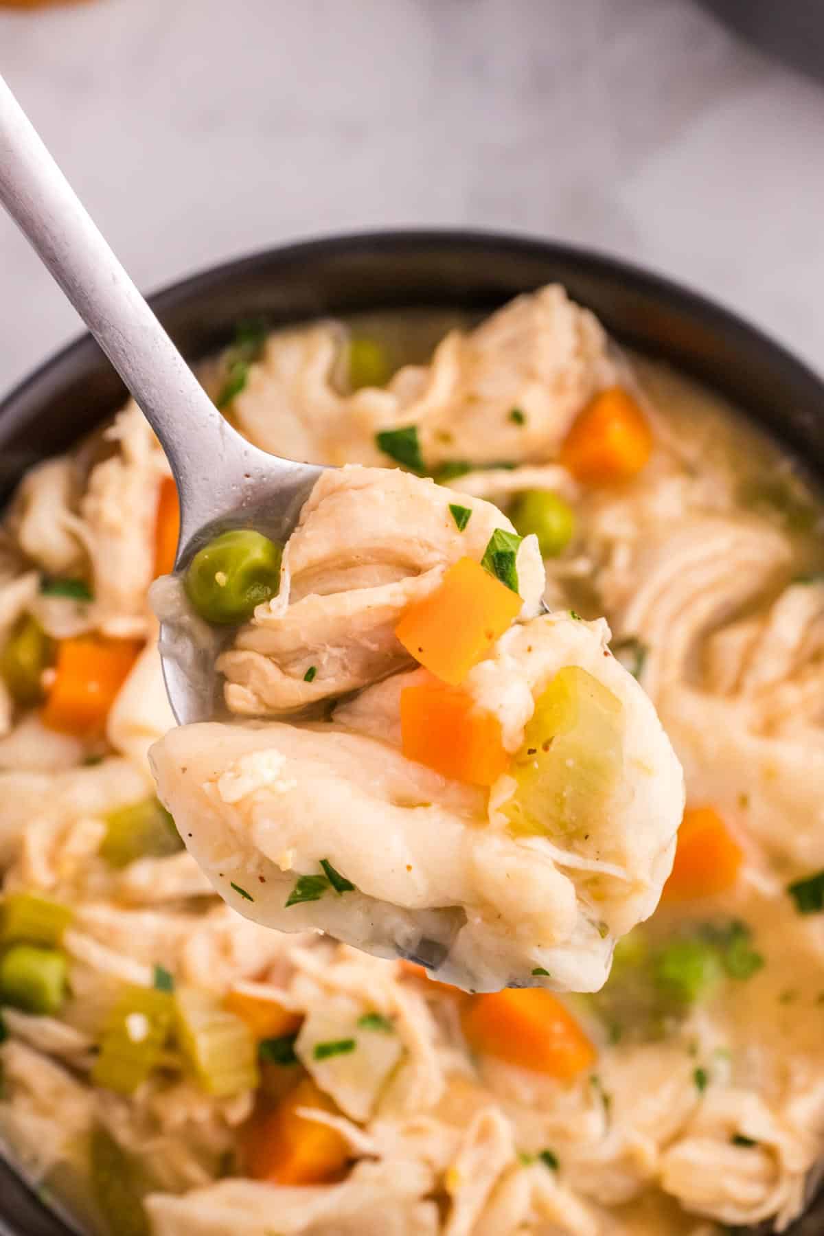 Chicken and Dumplings with Tortillas is a twist on a classic comfort food recipe loaded with shredded chicken breast, carrots, celery, onion, peas and flour tortilla recipes all cooked in a delicious chicken broth.