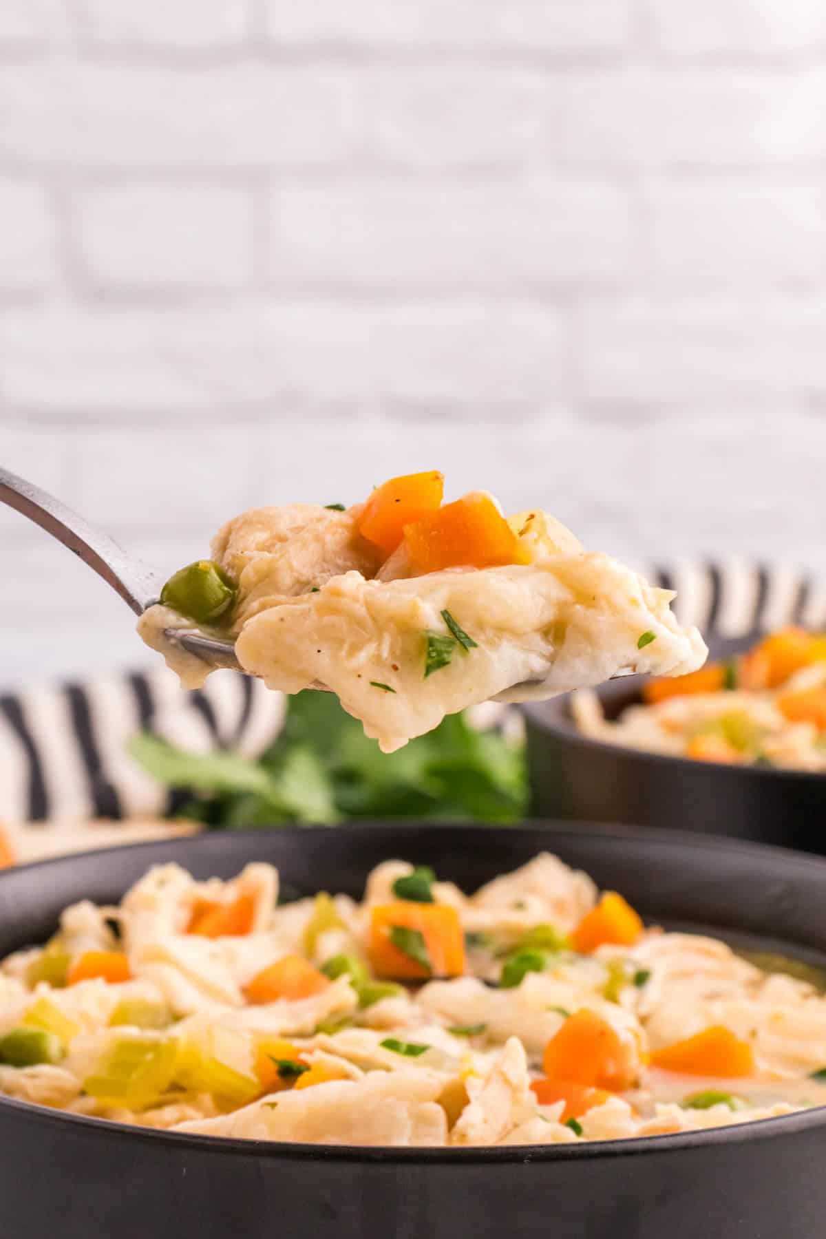 Chicken and Dumplings with Tortillas is a twist on a classic comfort food recipe loaded with shredded chicken breast, carrots, celery, onion, peas and flour tortilla recipes all cooked in a delicious chicken broth.