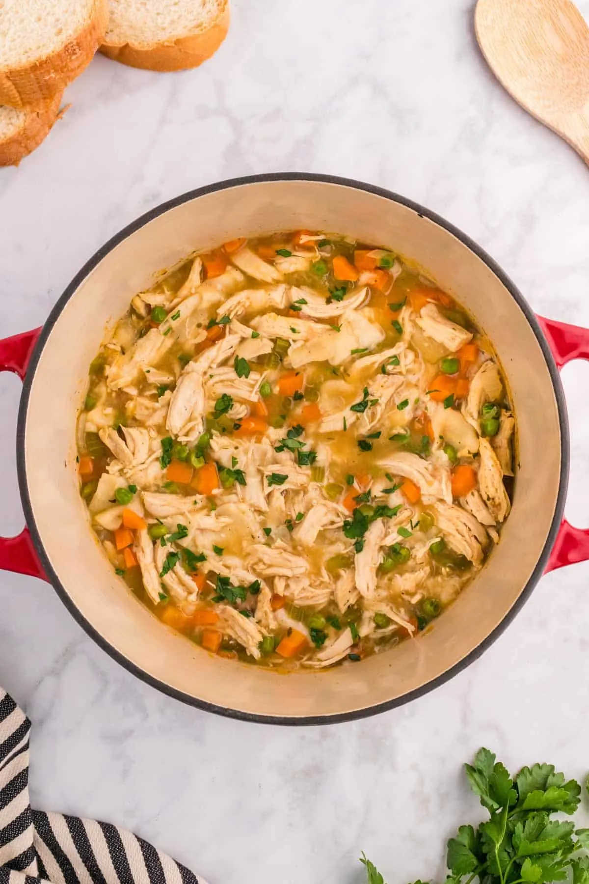 Chicken and Dumplings with Tortillas is a twist on a classic comfort food recipe loaded with shredded chicken breast, carrots, celery, onion, peas and flour tortilla recipes all cooked in a delicious chicken broth.