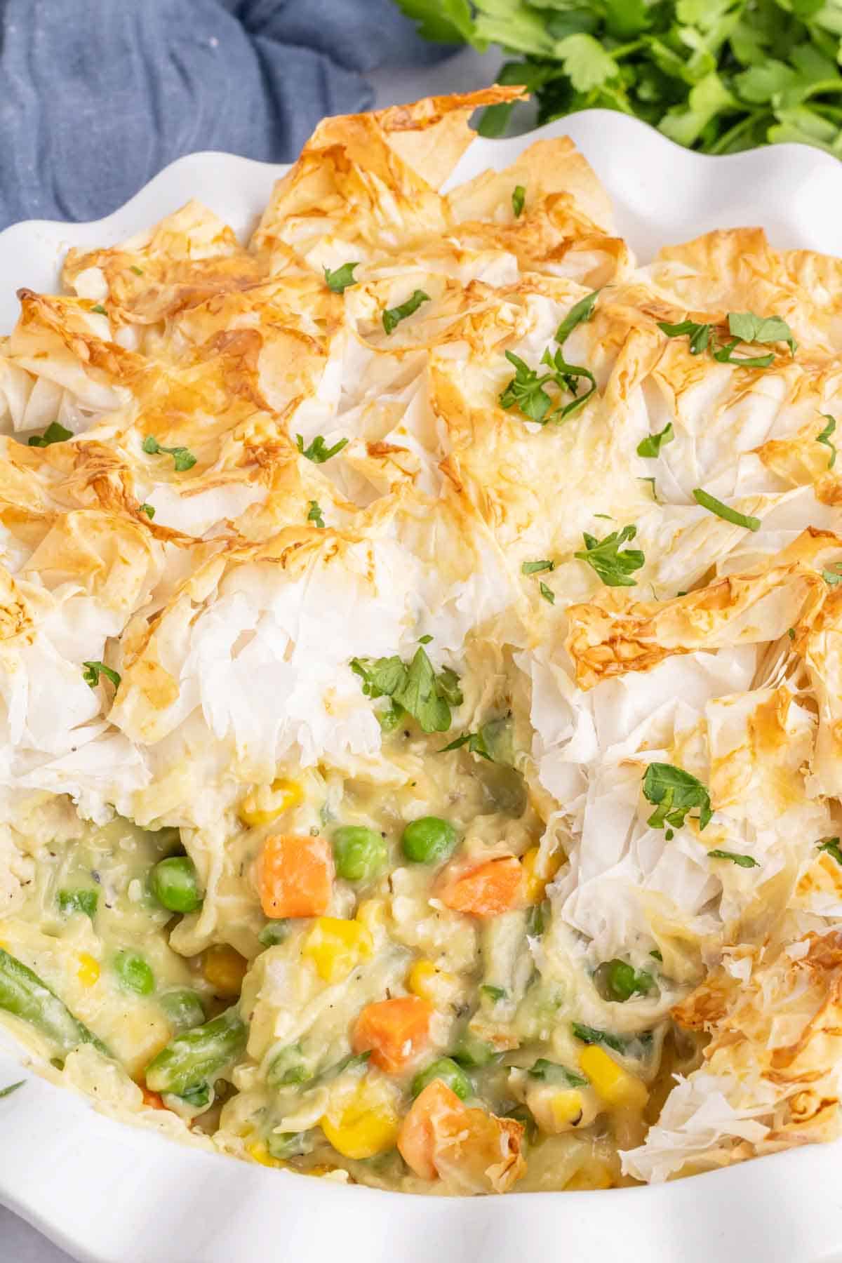 Chicken Pot Pie with Phyllo Dough is a hearty dinner recipe using shredded rotisserie chicken, frozen mixed vegetables, cream of chicken soup and sheets of phyllo dough.