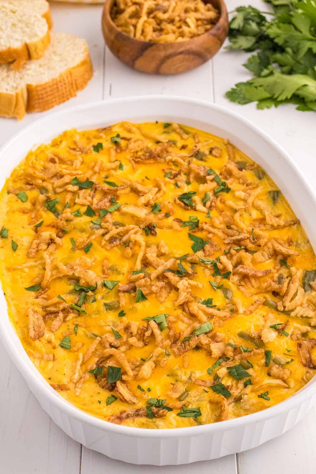 Green Bean Casserole with Velveeta is a classic holiday side dish made with canned green beans, cream of mushroom soup, Velveeta, shredded cheddar cheese and French's crispy fried onions.