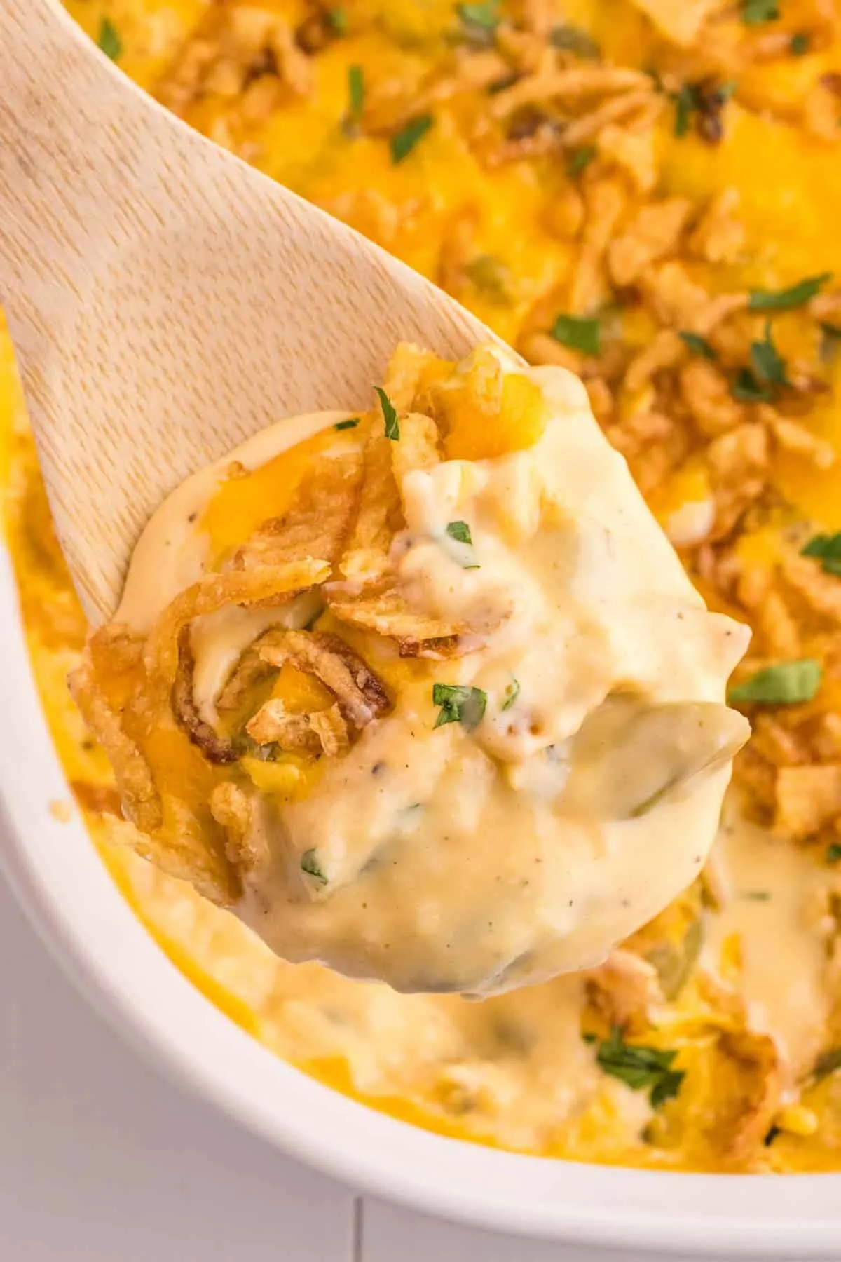 Green Bean Casserole with Velveeta is a classic holiday side dish made with canned green beans, cream of mushroom soup, Velveeta, shredded cheddar cheese and French's crispy fried onions.