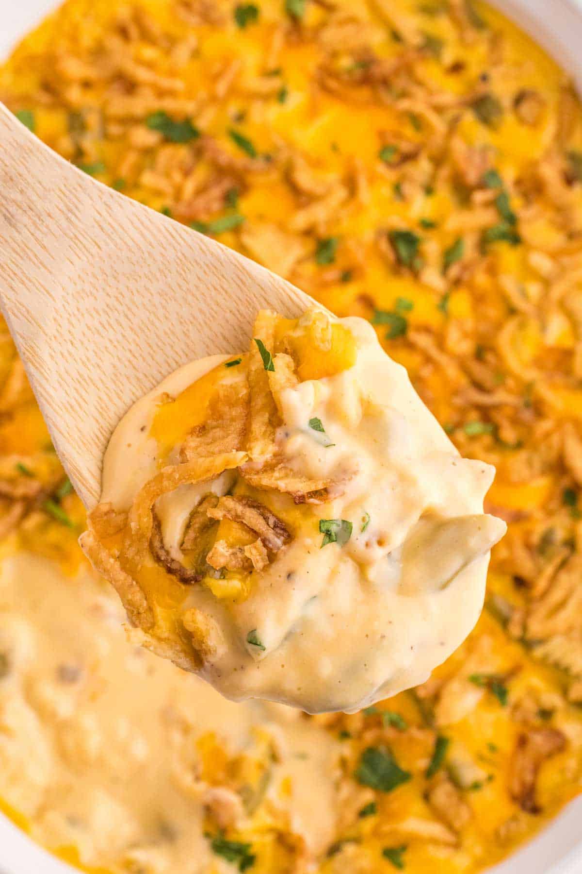 Green Bean Casserole with Velveeta is a classic holiday side dish made with canned green beans, cream of mushroom soup, Velveeta, shredded cheddar cheese and French's crispy fried onions.