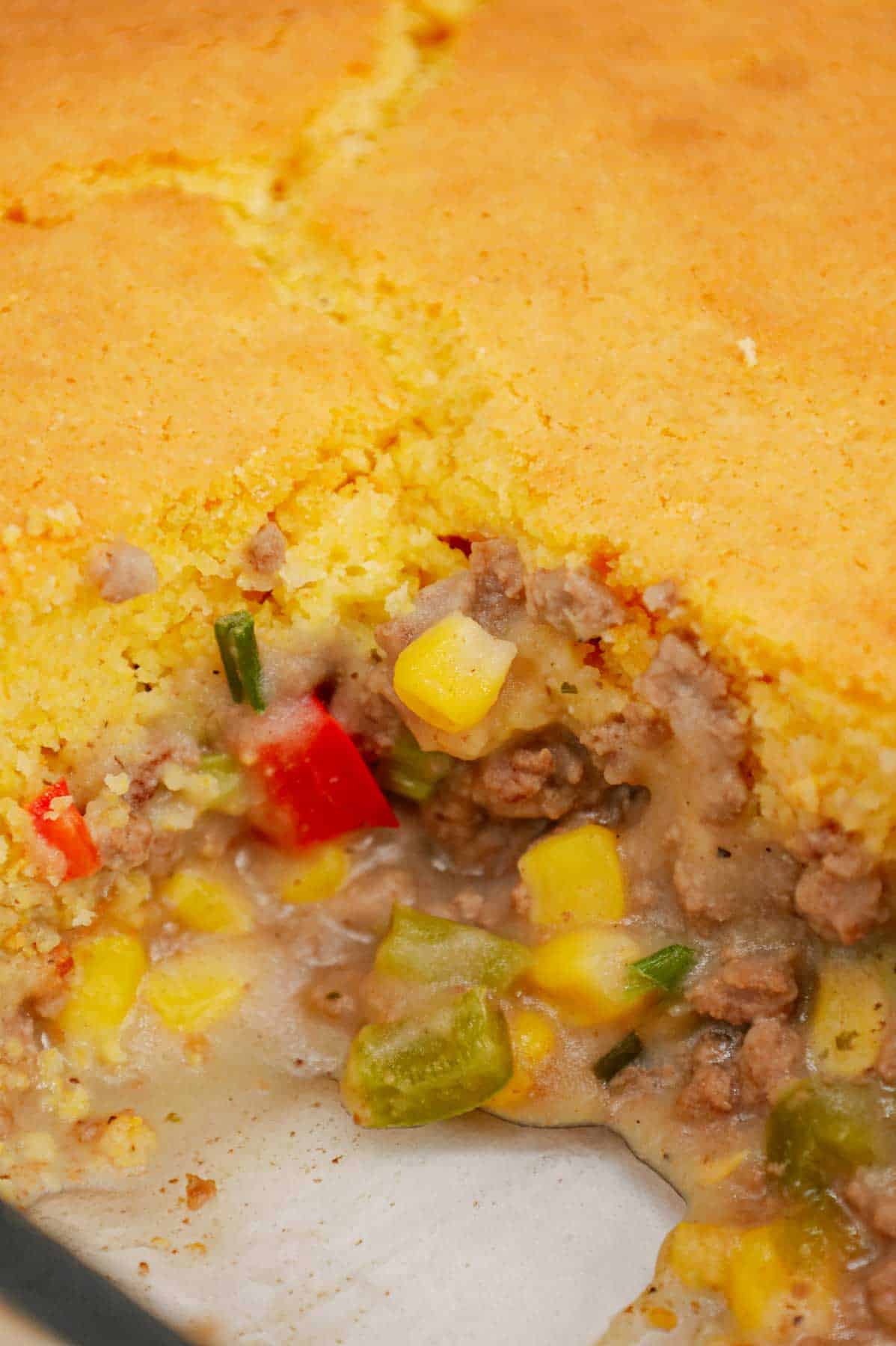 Shepherd's Pie with Cornbread is a Tex-Mex twist on a classic dish using Jiffy corn muffin mix, diced red and green peppers, corn, ground beef, instant mashed potatoes and chopped green onions.
