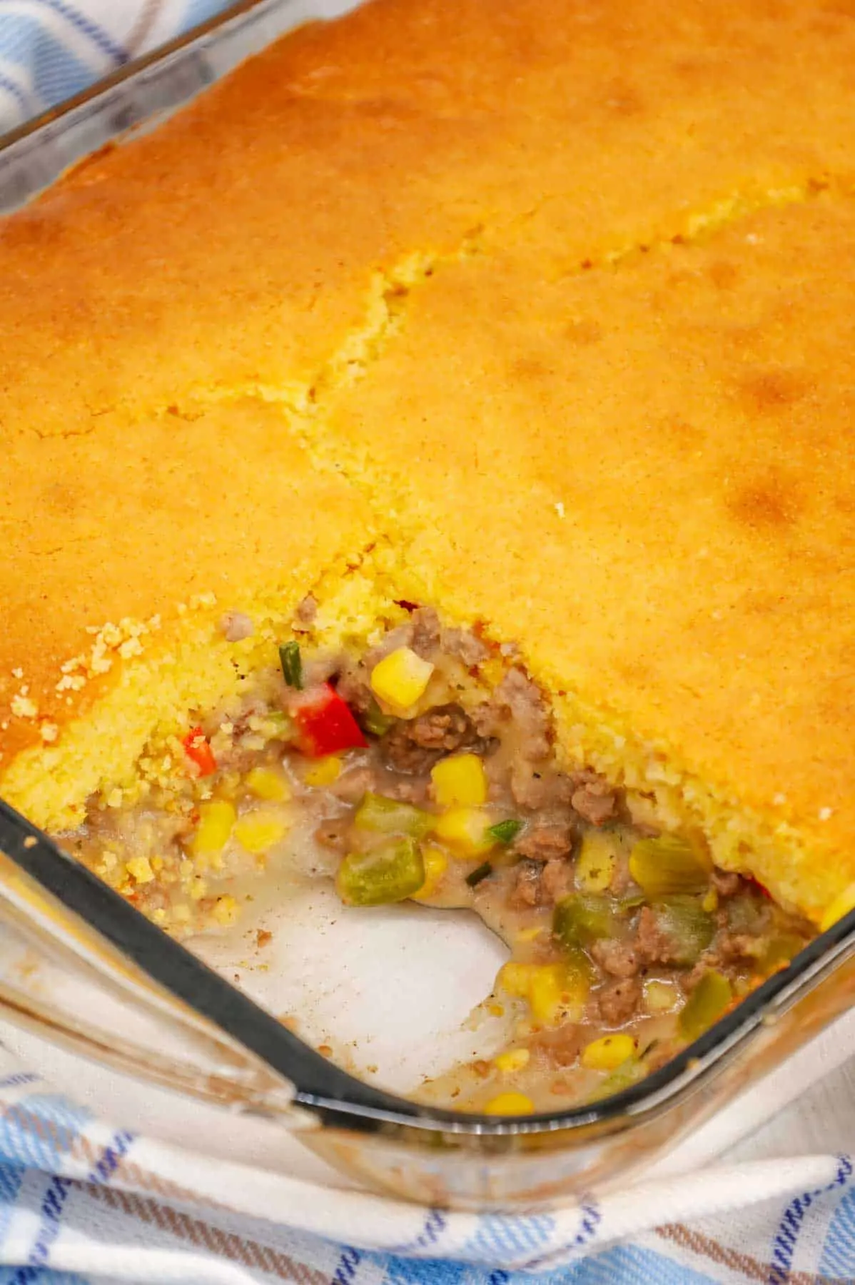 Shepherd's Pie with Cornbread is a Tex-Mex twist on a classic dish using Jiffy corn muffin mix, diced red and green peppers, corn, ground beef, instant mashed potatoes and chopped green onions.