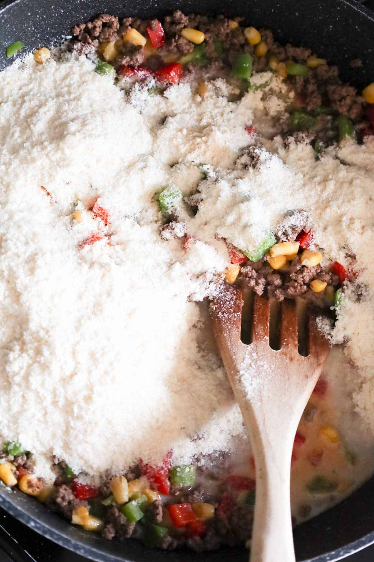 instant mashed potato mix added to skillet with ground beef and veggie mixture