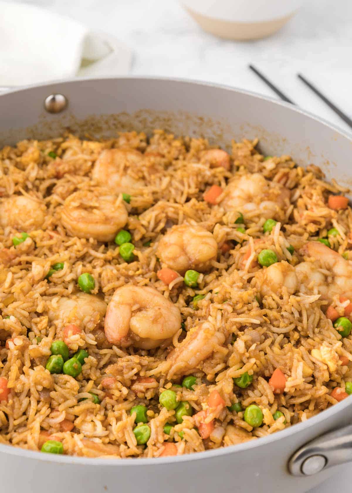 Easy Shrimp Fried Rice is a delicious dinner recipe loaded with shrimp, peas, carrots, onions, eggs, rice and soy sauce.