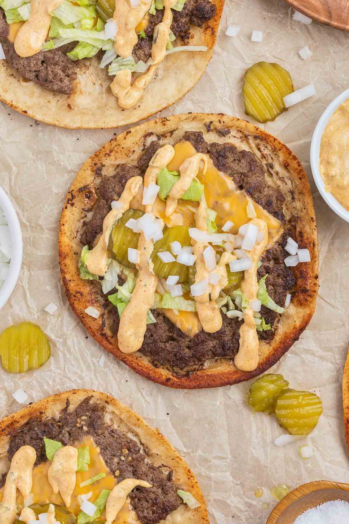 Smash Burger Tacos are a delightful fusion of two classic foods made with flour tortillas topped with ground beef patties, cheese, onions, pickles, shredded lettuce and homemade copycat Big Mac sauce.