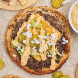 Smash Burger Tacos are a delightful fusion of two classic foods made with flour tortillas topped with ground beef patties, cheese, onions, pickles, shredded lettuce and homemade copycat Big Mac sauce.