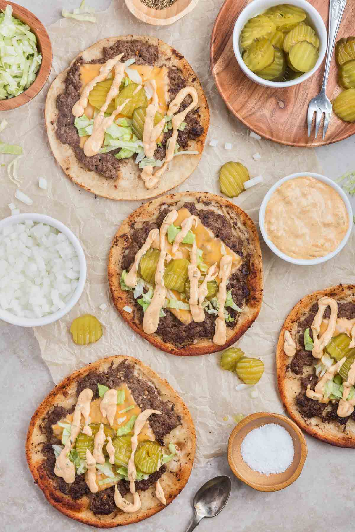 Smash Burger Tacos are a delightful fusion of two classic foods made with flour tortillas topped with ground beef patties, cheese, onions, pickles, shredded lettuce and homemade copycat Big Mac sauce.