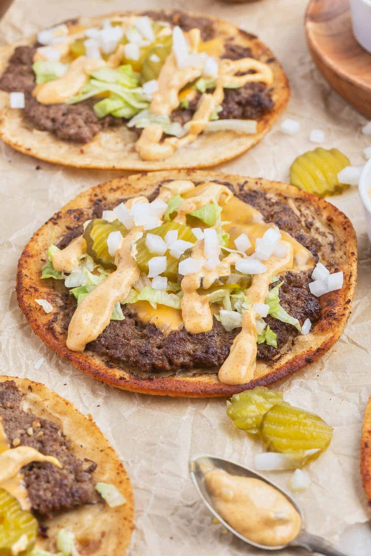 Smash Burger Tacos are a delightful fusion of two classic foods made with flour tortillas topped with ground beef patties, cheese, onions, pickles, shredded lettuce and homemade copycat Big Mac sauce.