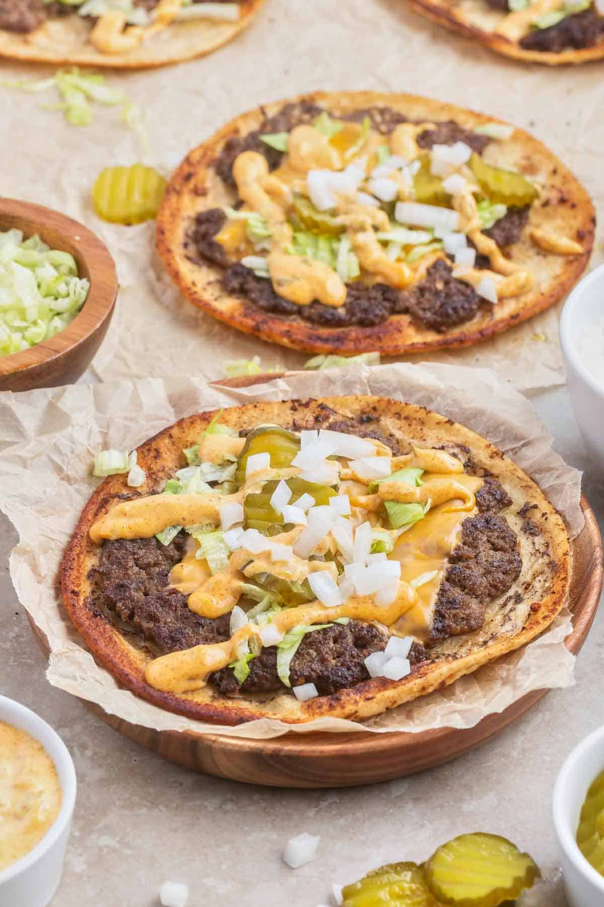 Smash Burger Tacos are a delightful fusion of two classic foods made with flour tortillas topped with ground beef patties, cheese, onions, pickles, shredded lettuce and homemade copycat Big Mac sauce.