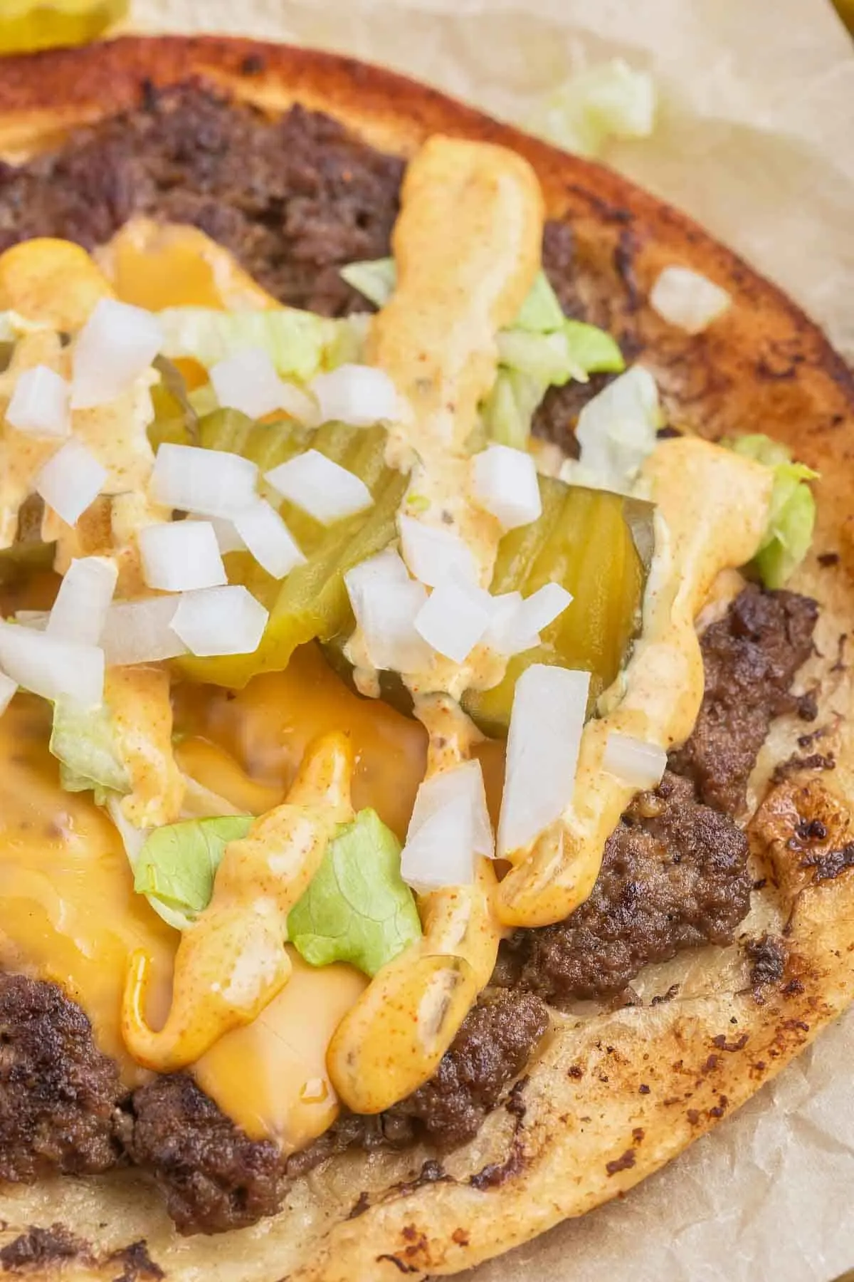 Smash Burger Tacos are a delightful fusion of two classic foods made with flour tortillas topped with ground beef patties, cheese, onions, pickles, shredded lettuce and homemade copycat Big Mac sauce.