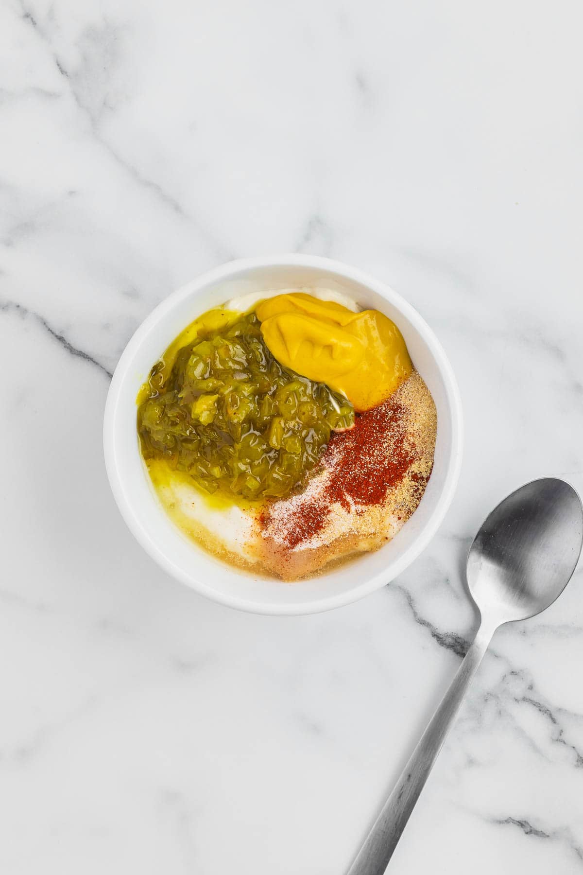 mayo, mustard, relish and spices in a small bowl