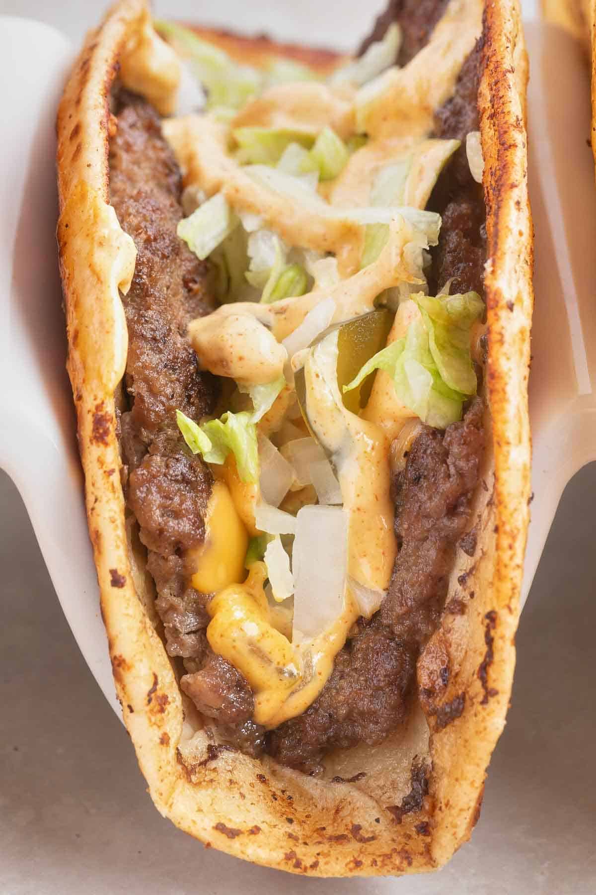 Smash Burger Tacos are a delightful fusion of two classic foods made with flour tortillas topped with ground beef patties, cheese, onions, pickles, shredded lettuce and homemade copycat Big Mac sauce.