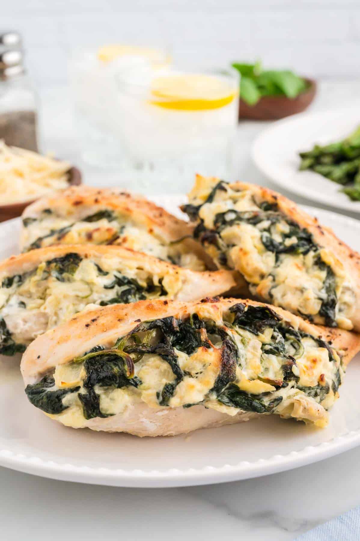 Spinach Artichoke Stuffed Chicken Breasts are a delicious boneless, skinless chicken breast recipe loaded with cream cheese, mozzarella, spinach and chopped artichoke hearts.