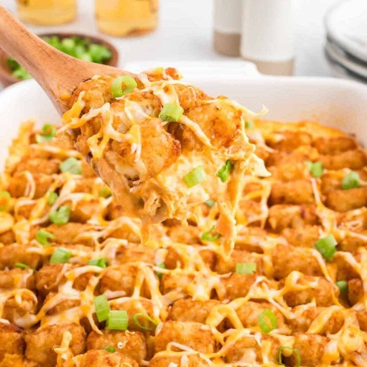 Buffalo Chicken Tater Tot Casserole is an easy family friendly dinner recipe  loaded with rotisserie chicken, cream of chicken soup, cream cheese, ranch dressing, Frank's Red Hot, tater tots, shredded cheese and chopped green onions.