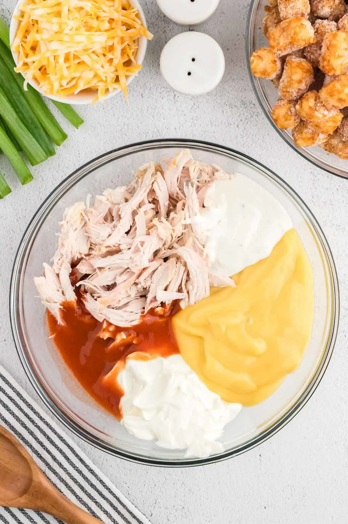 shredded chicken, ranch dressing, cream cheese, cream of chicken sauce and hot sauce in a mixing bowl