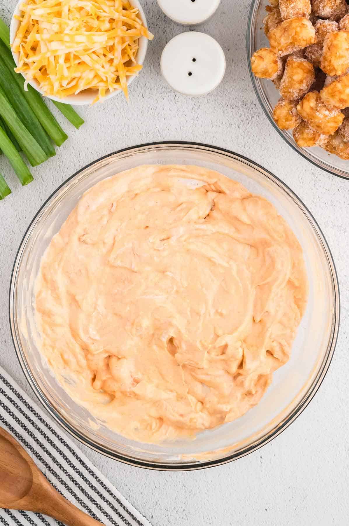 creamy buffalo chicken mixture in a mixing bowl