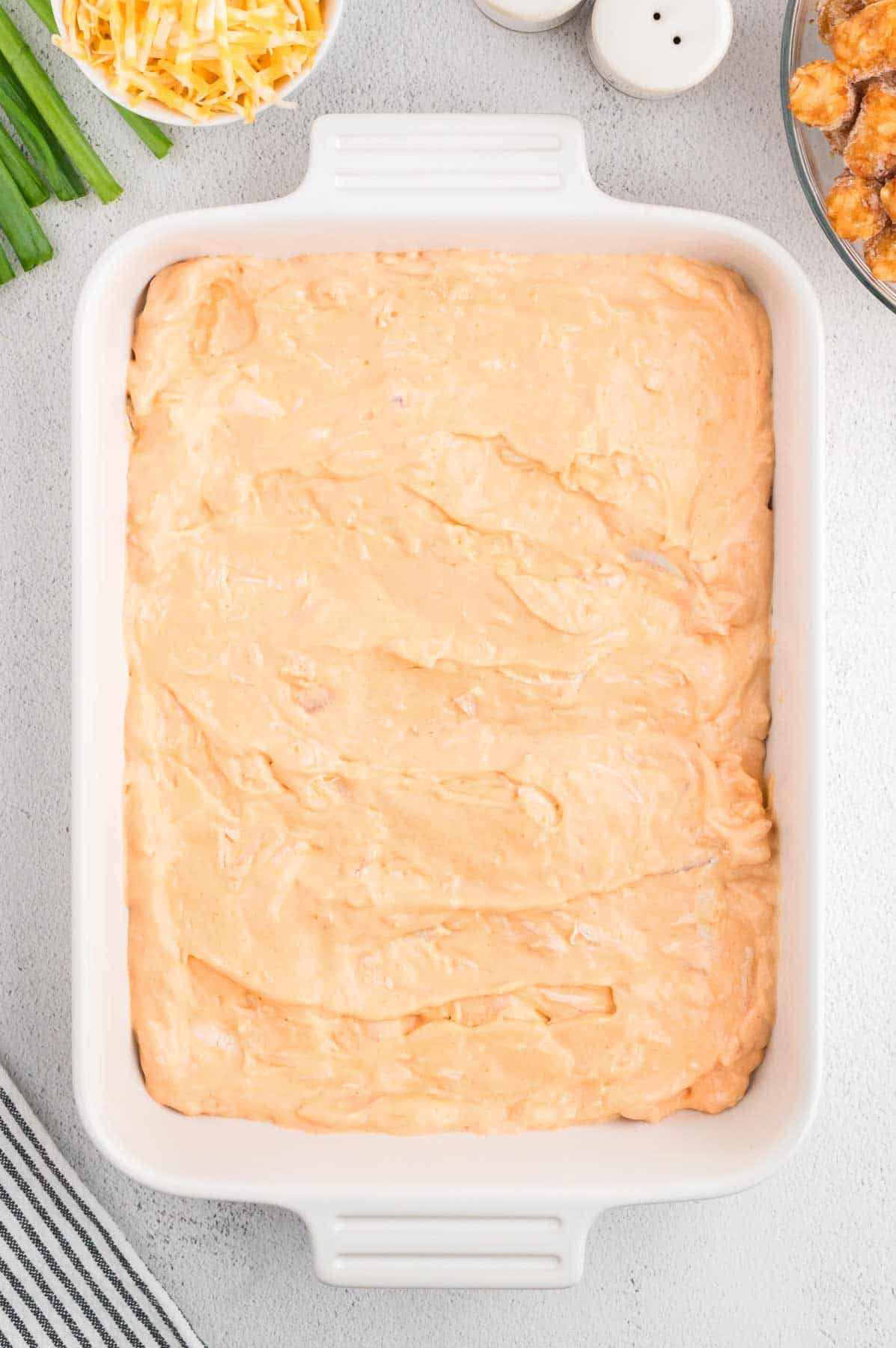 creamy Buffalo chicken mixture in a baking dish