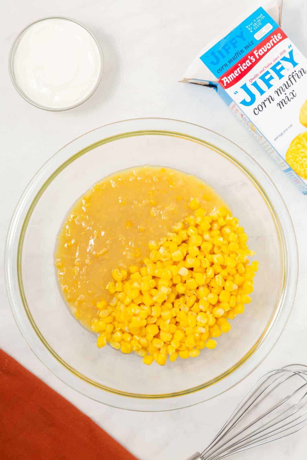 whole kernel corn and cream style corn in a mixing bowl