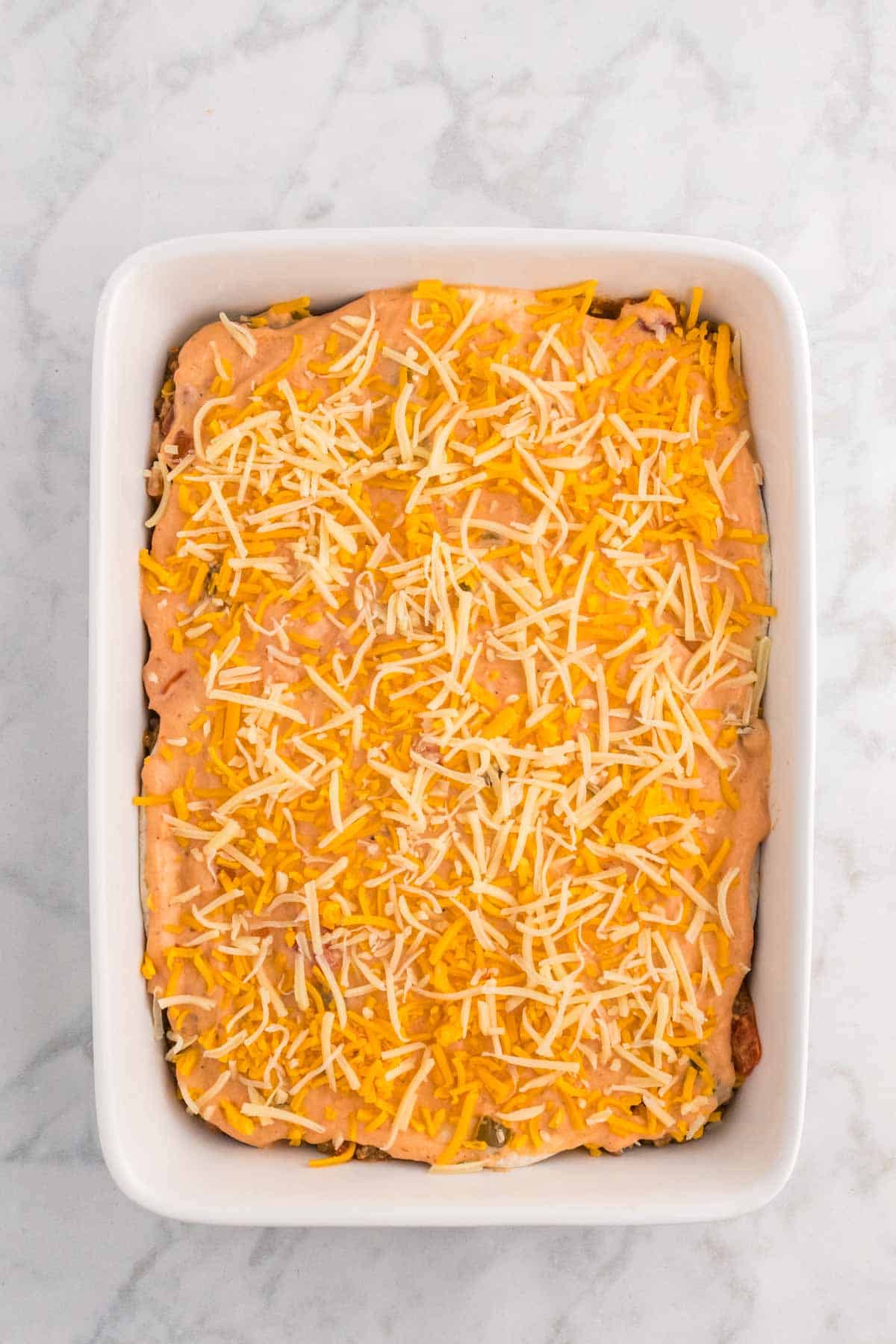 shredded cheddar and Monterey Jack cheese on top of beef burrito casserole