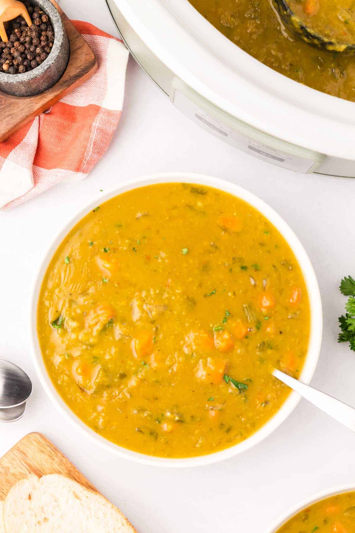 Crock Pot Split Pea Soup is a hearty slow cooker soup recipe made with split peas, carrots, celery, onions, vegetable broth and seasonings.