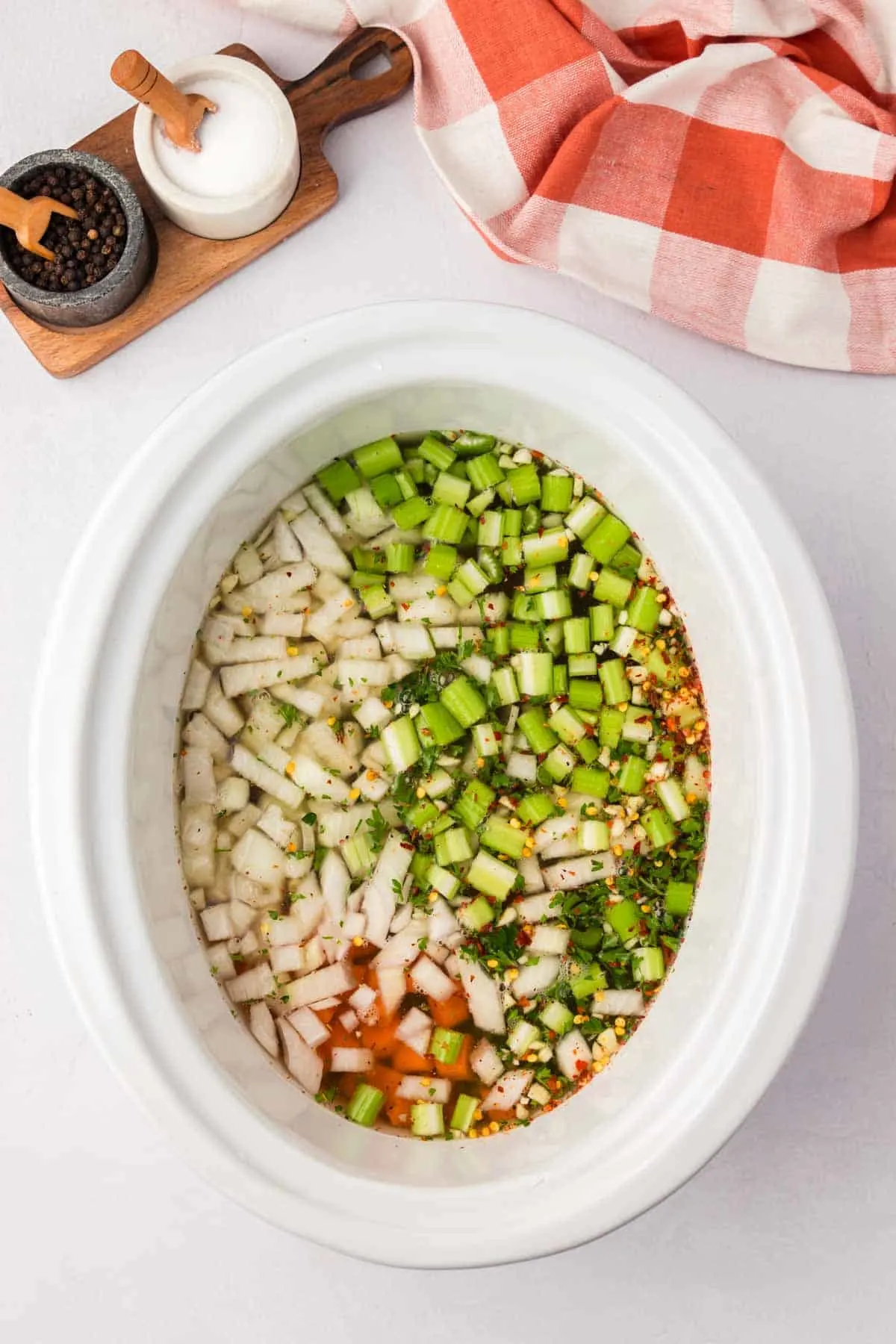chopped celery, carrots, onions and vegetable broth in a crock pot