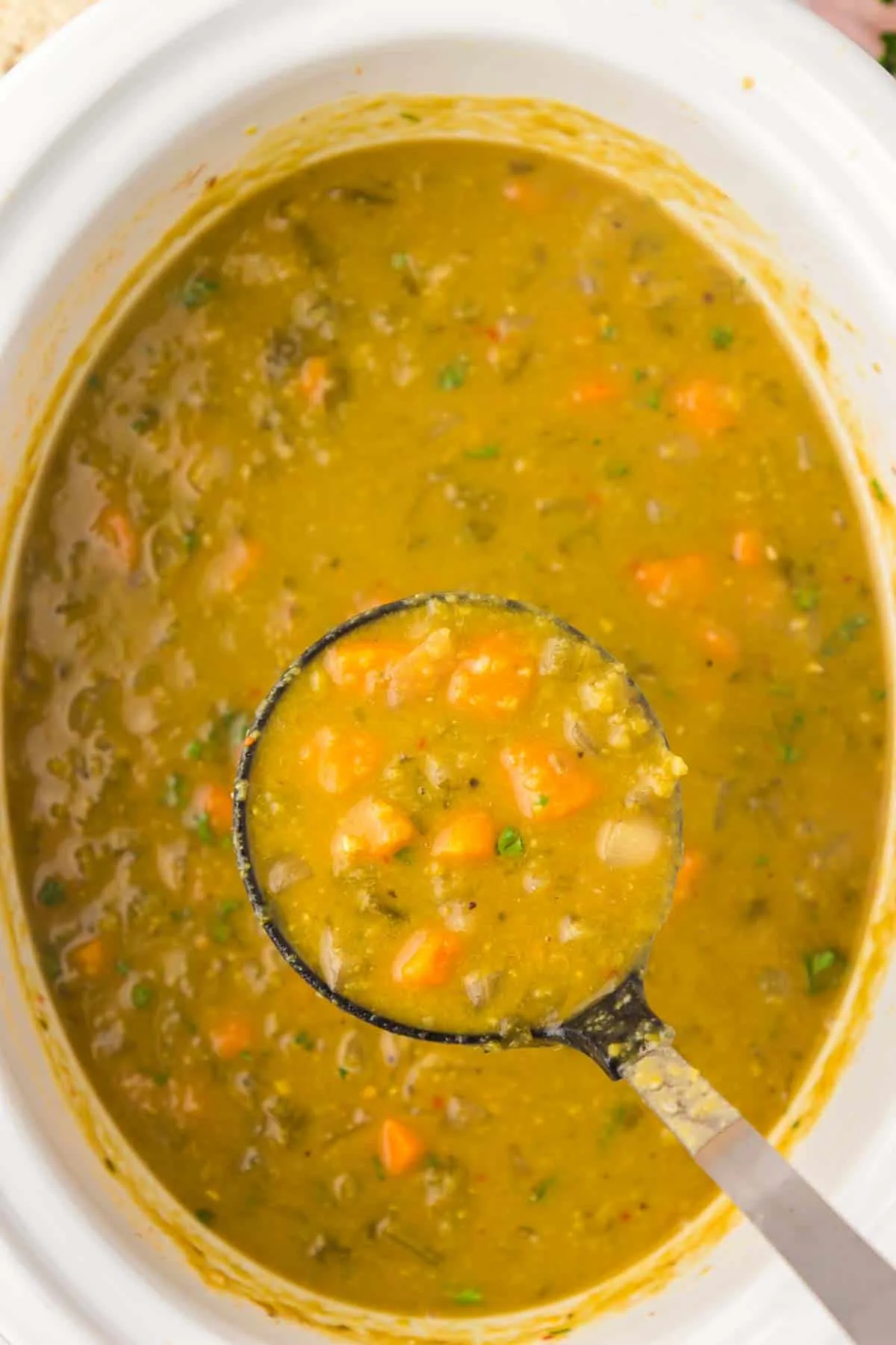 Crock Pot Split Pea Soup is a hearty slow cooker soup recipe made with split peas, carrots, celery, onions, vegetable broth and seasonings.