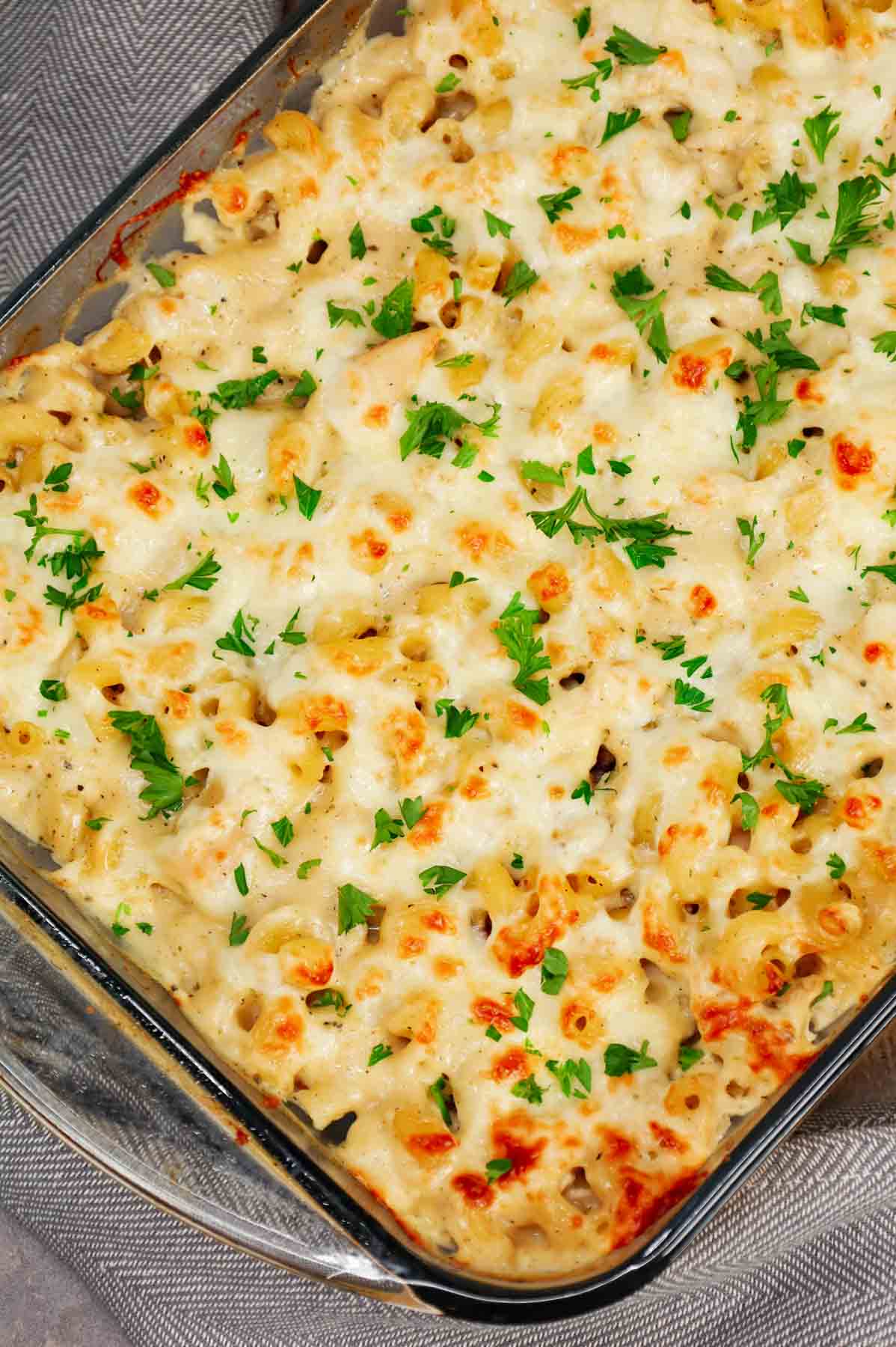 Dump and Bake Chicken Alfredo is an easy one dish meal made with cavatappi pasta, jarred alfredo sauce, condensed cream of bacon soup, chicken broth, chopped rotisserie chicken and mozzarella cheese.