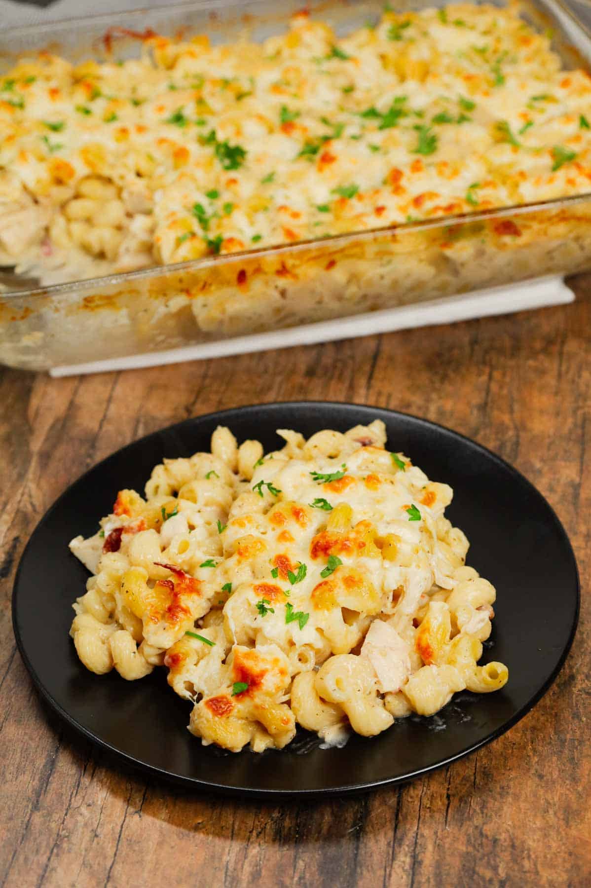 Dump and Bake Chicken Alfredo is an easy one dish meal made with cavatappi pasta, jarred alfredo sauce, condensed cream of bacon soup, chicken broth, chopped rotisserie chicken and mozzarella cheese.