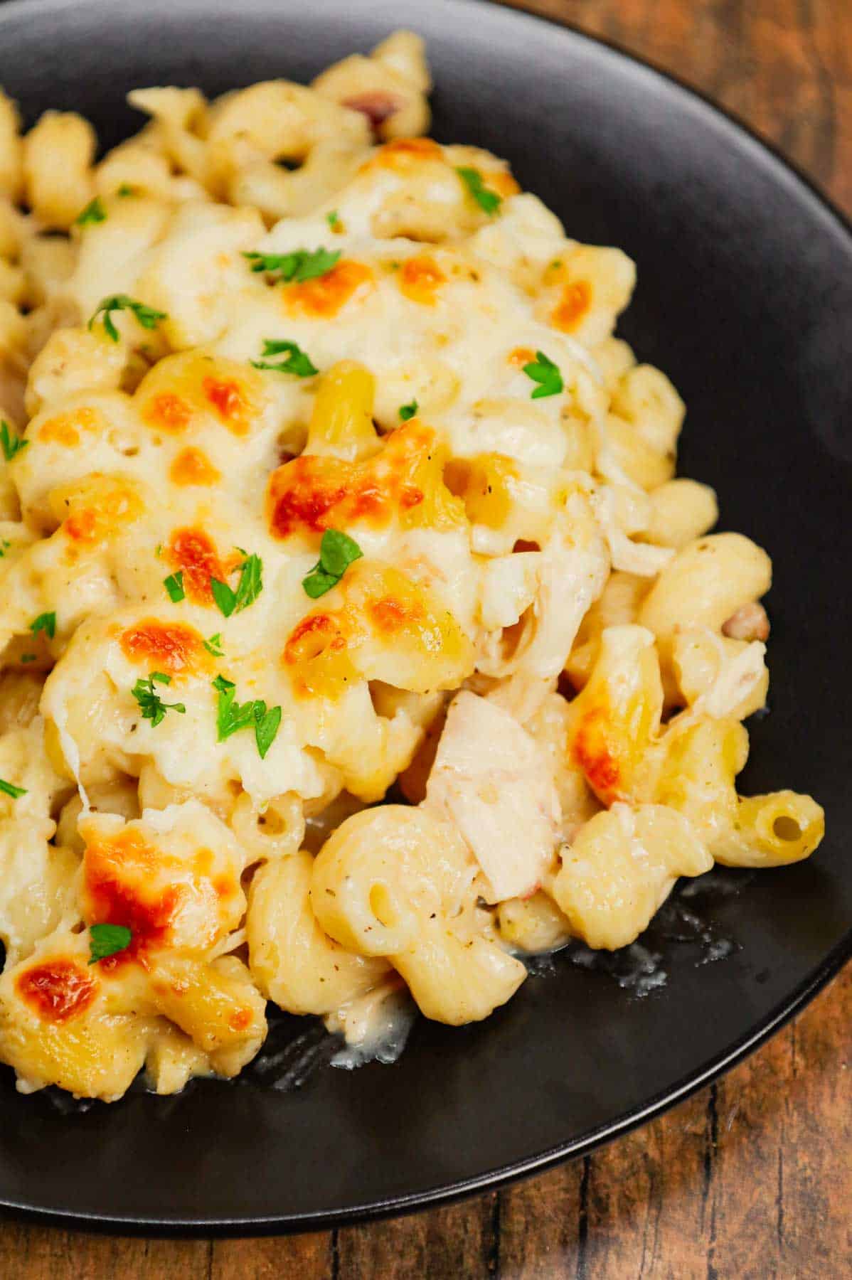 Dump and Bake Chicken Alfredo is an easy one dish meal made with cavatappi pasta, jarred alfredo sauce, condensed cream of bacon soup, chicken broth, chopped rotisserie chicken and mozzarella cheese.