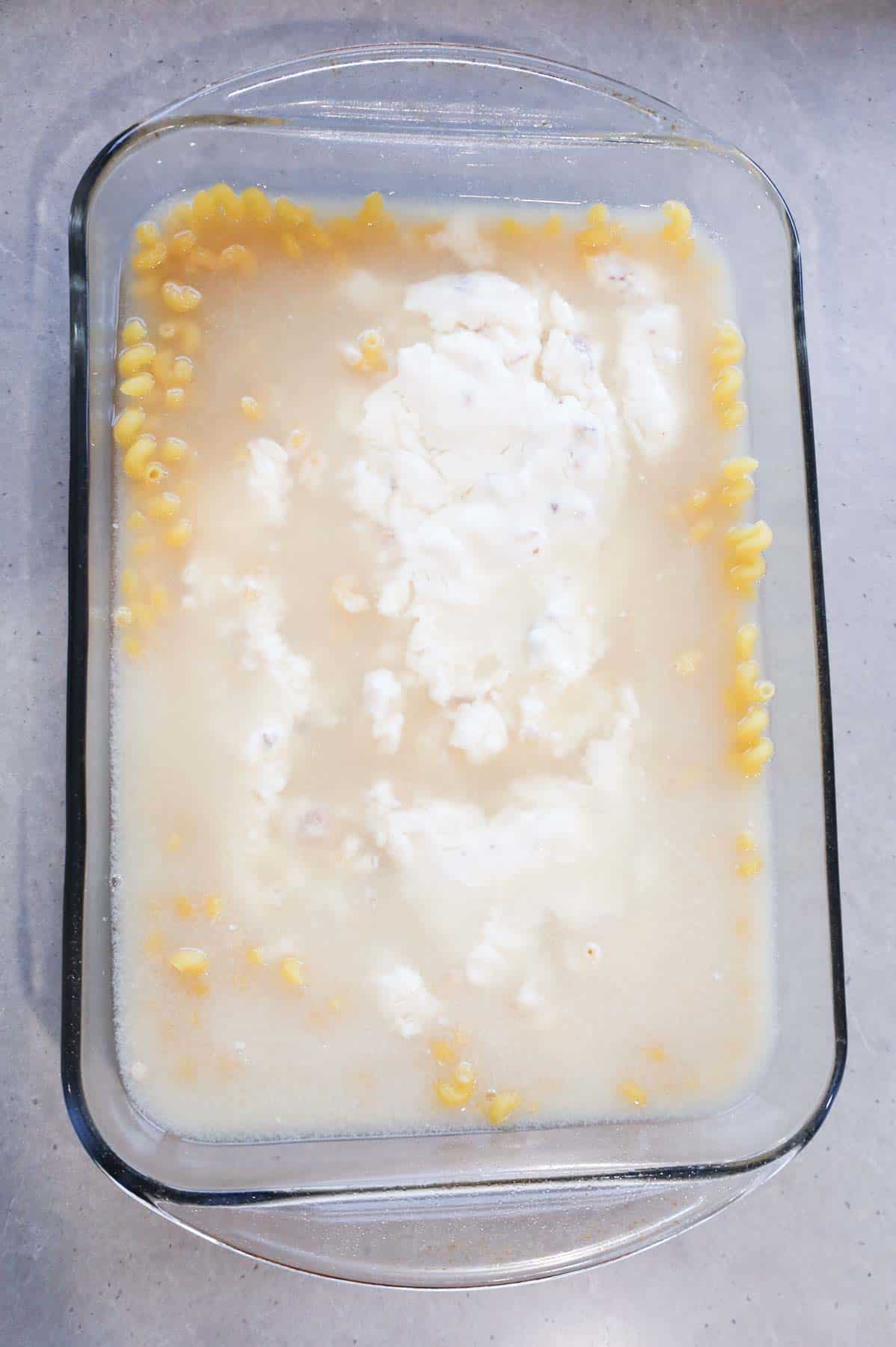 chicken broth, alfredo sauce, cream of bacon soup poured over cavatappi noodles in a baking dish