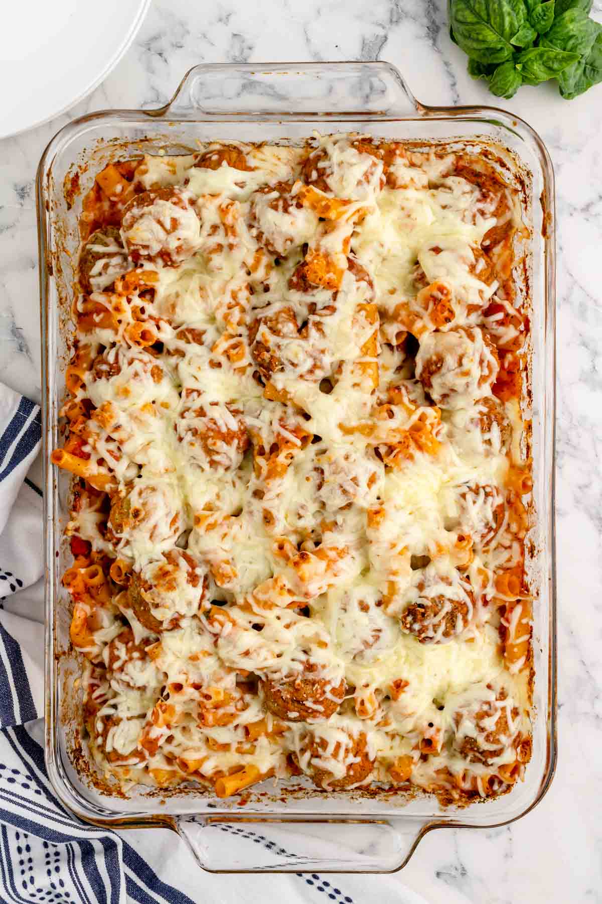 Dump and Bake Meatball Pasta Casserole is an easy dinner recipe with ziti noodles, chicken stock, pasta sauce, Italian seasoning and turkey meatballs all cooked together in one dish and then topped with mozzarella cheese.