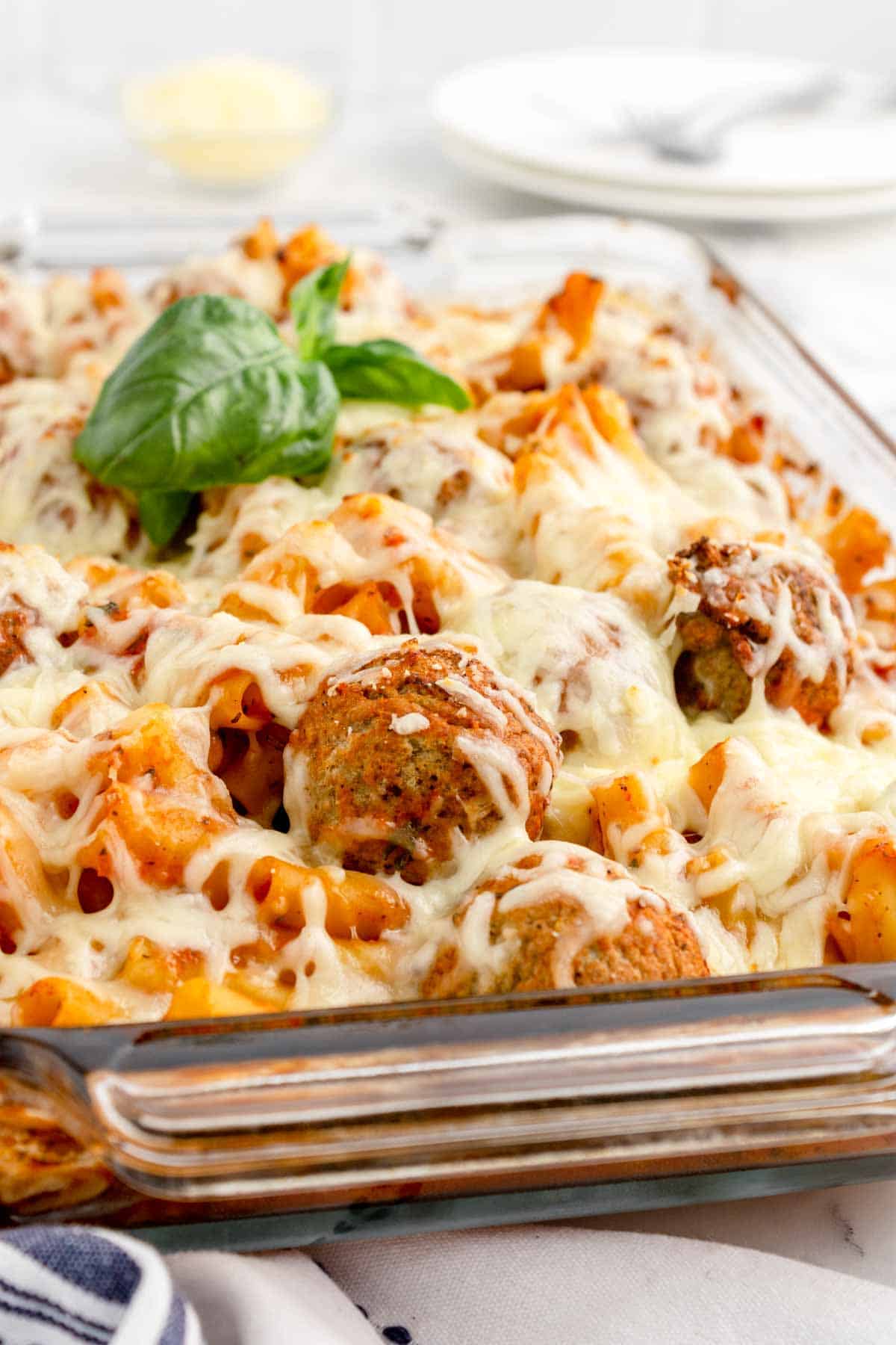 Dump and Bake Meatball Pasta Casserole is an easy dinner recipe with ziti noodles, chicken stock, pasta sauce, Italian seasoning and turkey meatballs all cooked together in one dish and then topped with mozzarella cheese.