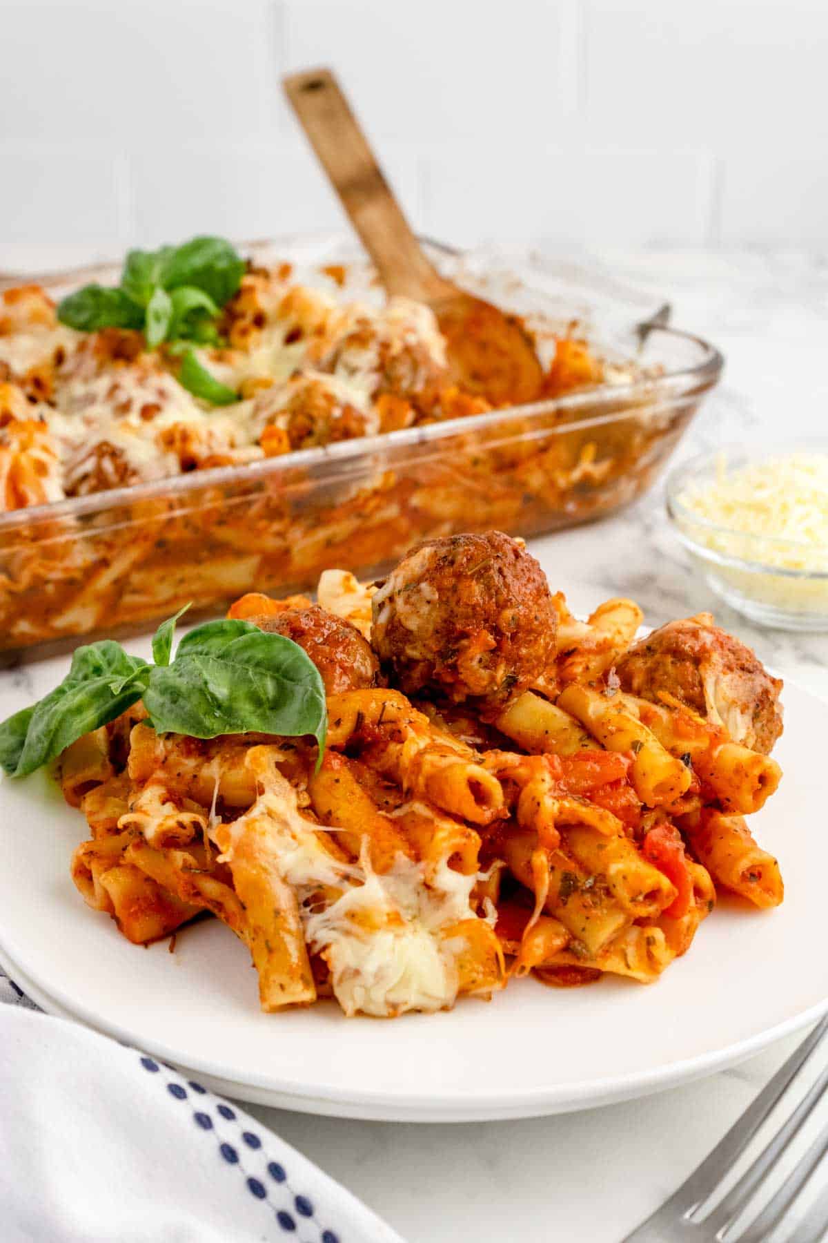 Dump and Bake Meatball Pasta Casserole is an easy dinner recipe with ziti noodles, chicken stock, pasta sauce, Italian seasoning and turkey meatballs all cooked together in one dish and then topped with mozzarella cheese.