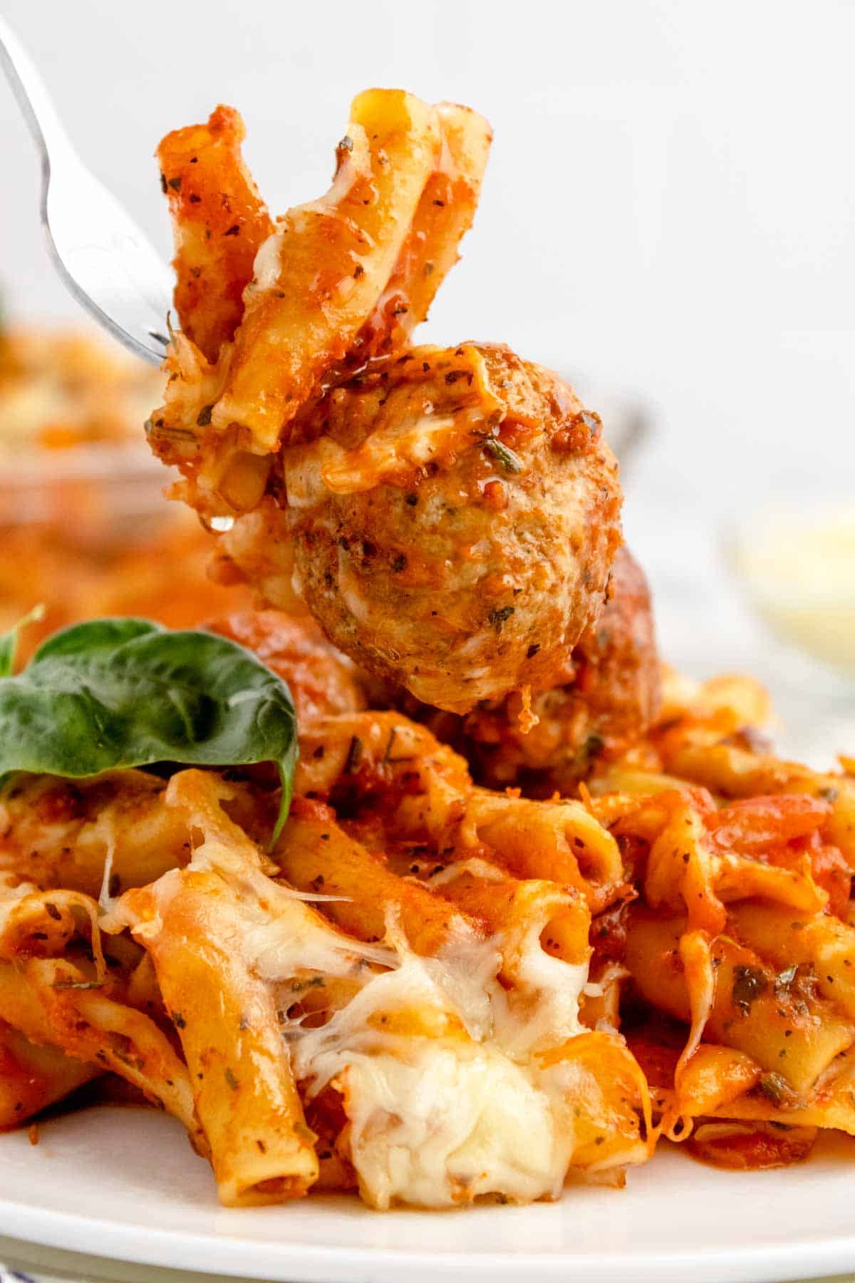 Dump and Bake Meatball Pasta Casserole is an easy dinner recipe with ziti noodles, chicken stock, pasta sauce, Italian seasoning and turkey meatballs all cooked together in one dish and then topped with mozzarella cheese.