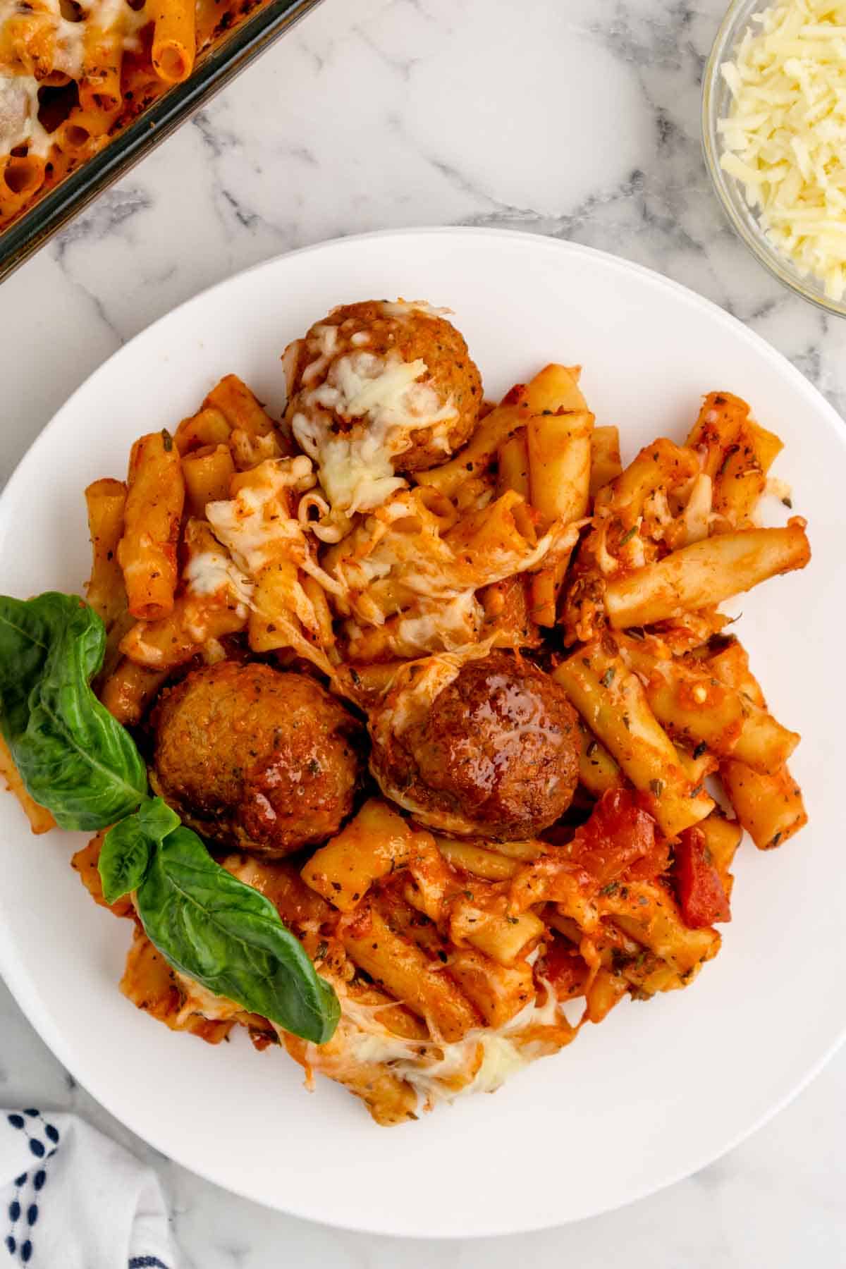 Dump and Bake Meatball Pasta Casserole is an easy dinner recipe with ziti noodles, chicken stock, pasta sauce, Italian seasoning and turkey meatballs all cooked together in one dish and then topped with mozzarella cheese.