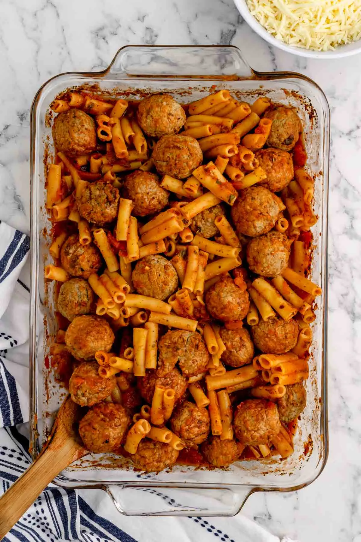 cooked meatballs and ziti noodles in a baking dish