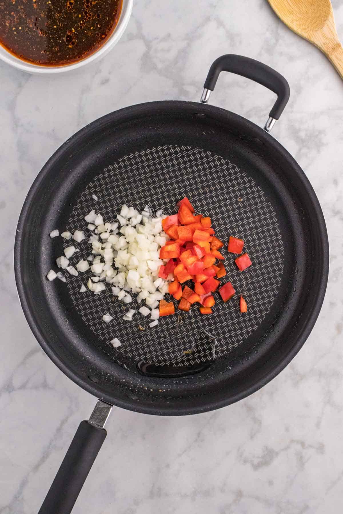 diced onions and red bell peppers in a skillet