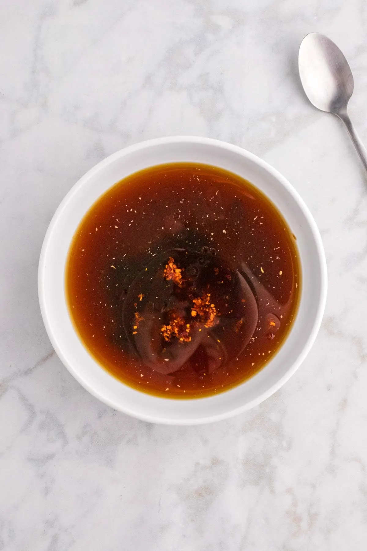 hoisin sauce, soy sauce, oyster sauce, honey, chili garlic sauce and chicken broth in bowl