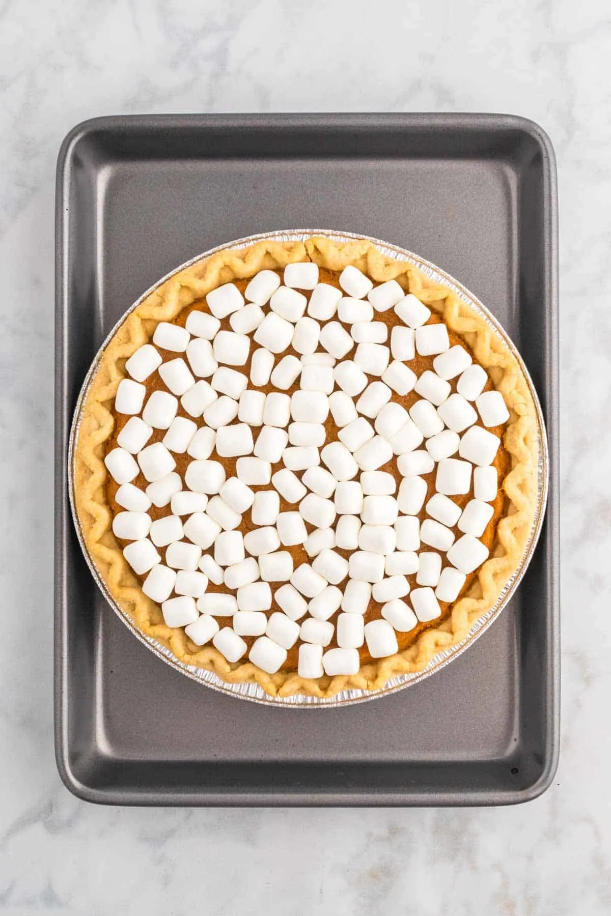 mini marshmallows on top of a sweet potato pie